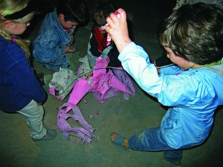 Kids tearing apart a piñata